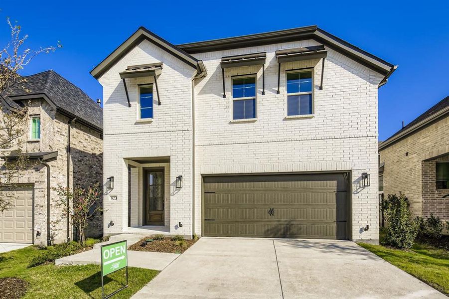 View of front of property with driveway, brick siding, and an attached garage View of front of property with driveway, brick siding, and an attached garage