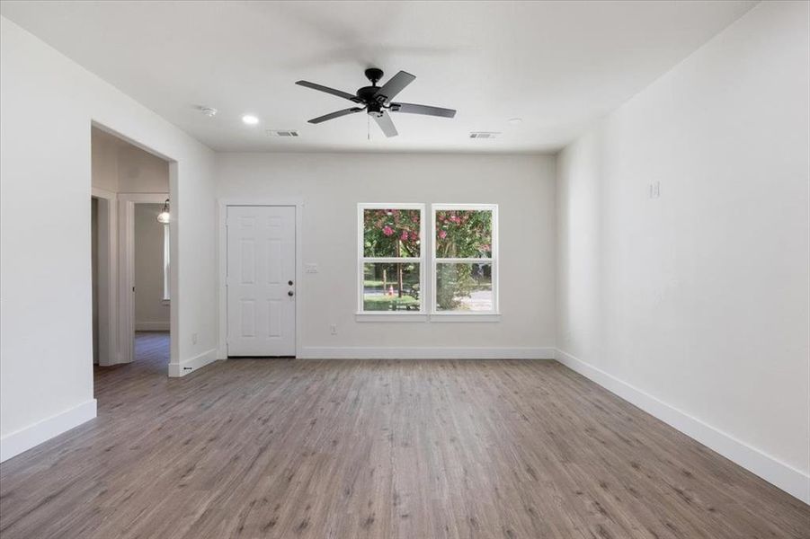 Spare room with wood-type flooring and ceiling fan