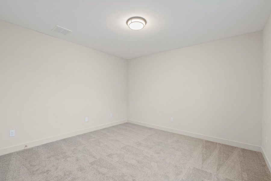 Neutral wall paint, light gray carpeting, recessed ceiling vent, flush-mount ceiling light fixture, and white baseboards Neutral wall paint, light gray carpeting, recessed ceiling vent, flush-mount ceiling light fixture, and white baseboards