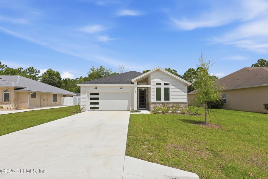 Front exterior of a new home in Palm Coast Homes, Palm Coast, FL, highlighting curb appeal (Image 29).