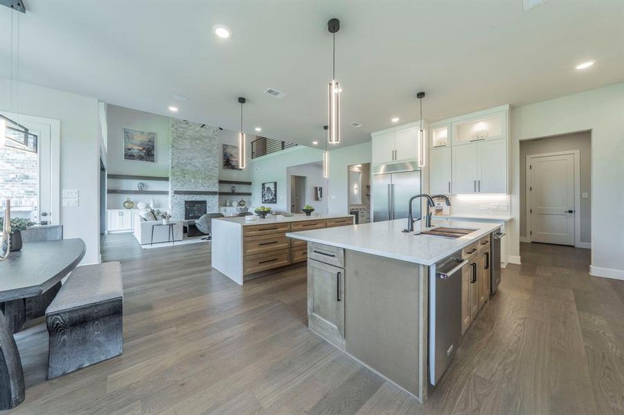 Kitchen featuring a spacious island, appliances with stainless steel finishes, open floor plan, dark wood-style flooring, and recessed lighting Kitchen featuring a spacious island, appliances with stainless steel finishes, open floor plan, dark wood-style flooring, and recessed lighting