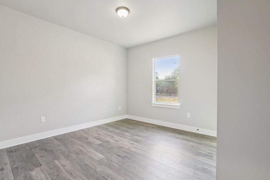 Empty room featuring light wood-style floors and baseboards