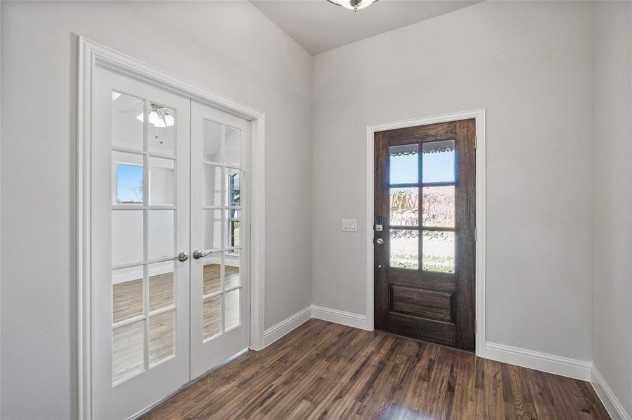 Doorway with french doors and wood finished floors