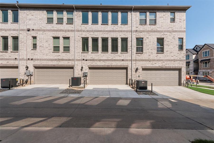 Front exterior of a new home in Wade Settlement Townhomes, Frisco, TX, highlighting curb appeal (Image 1). Front exterior of a new home in Wade Settlement Townhomes, Frisco, TX, highlighting curb appeal (Image 1).