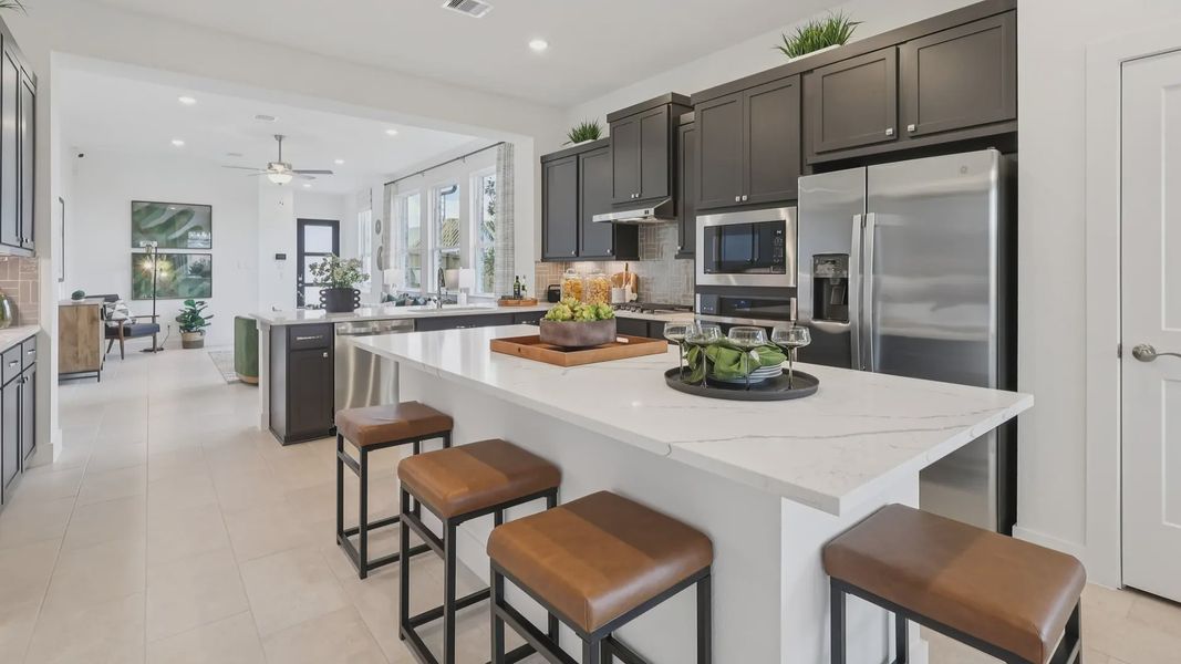 Representative furnished interior of a home built from the Adele by Chesmar Homes in Sunterra, Katy (Image 11).
