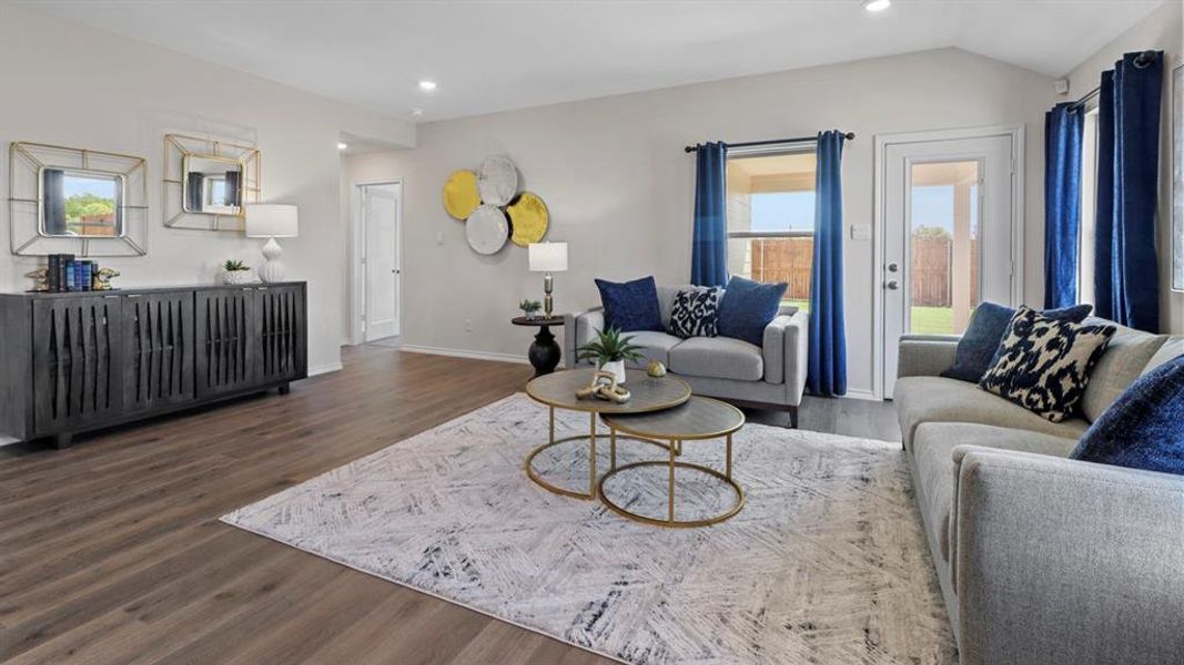 Living room with dark wood-style floors, recessed lighting, and lofted ceiling