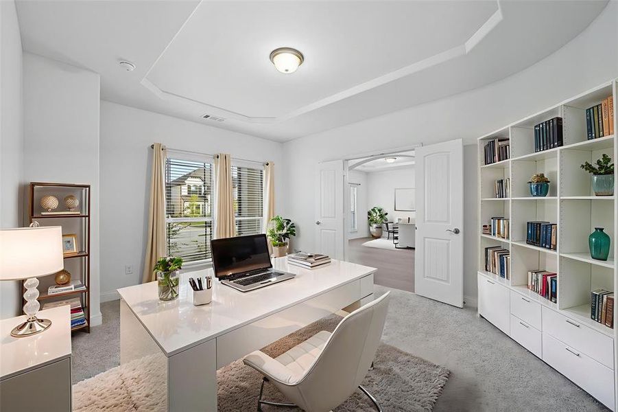 Office with light colored carpet and a raised ceiling Office with light colored carpet and a raised ceiling