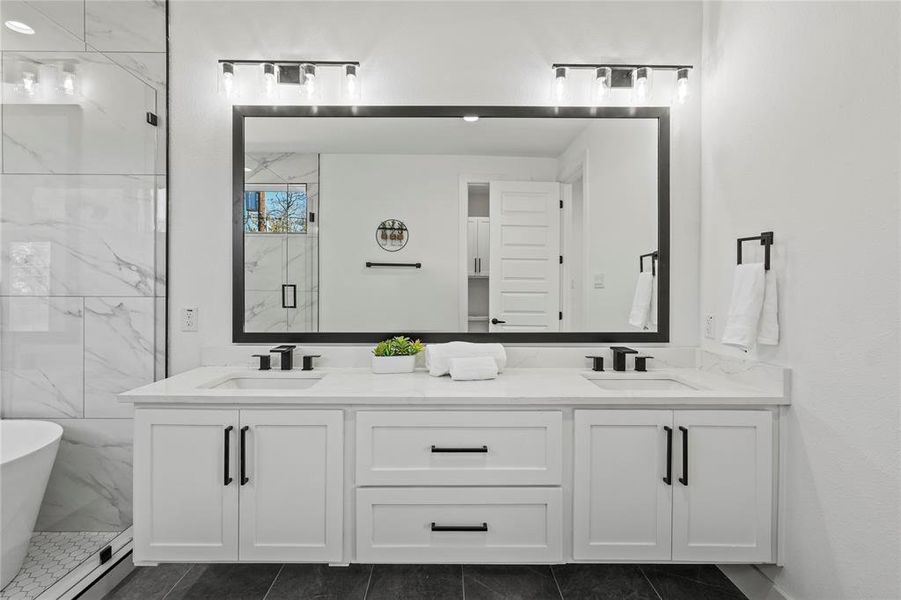 Bathroom featuring tile patterned flooring, vanity, and plus walk in shower