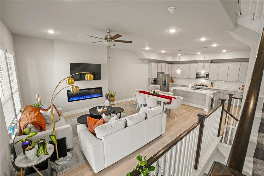 Living room featuring ceiling fan and light wood-type flooring