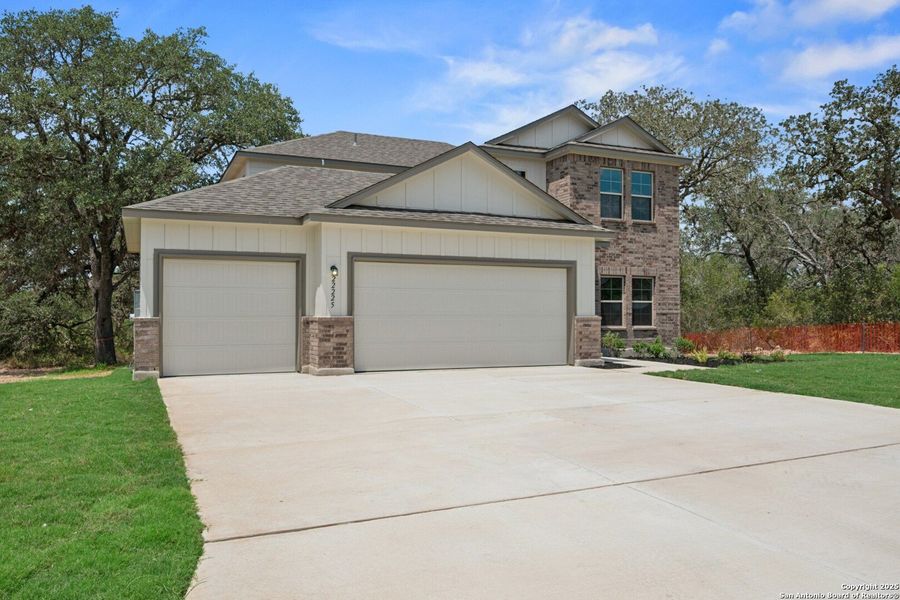 Front exterior of a new home in Jordan's Ranch, San Antonio, TX, highlighting curb appeal (Image 14). Front exterior of a new home in Jordan's Ranch, San Antonio, TX, highlighting curb appeal (Image 14).