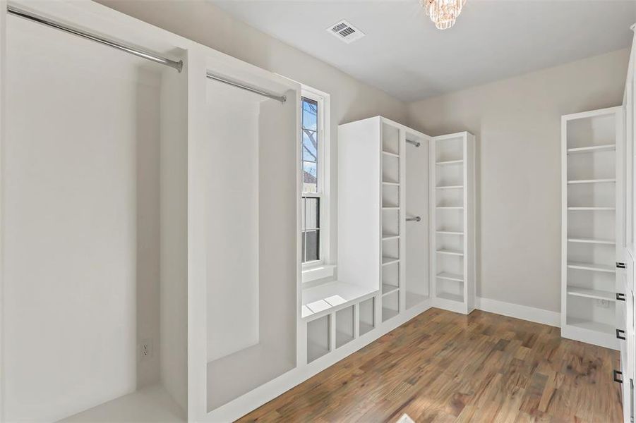 Spacious closet featuring dark wood-style floors Spacious closet featuring dark wood-style floors