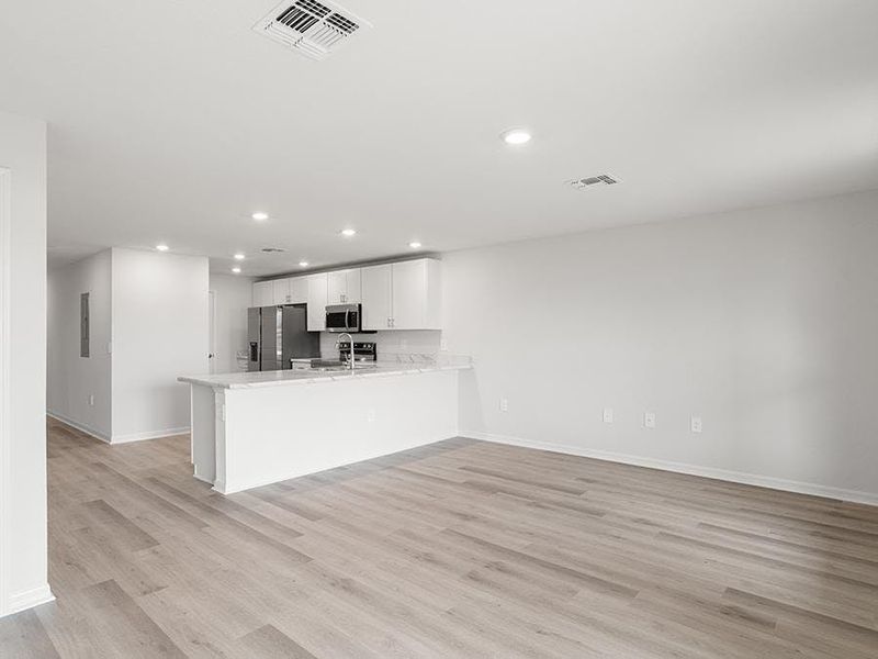 This 2-story townhome features a bright, open living area - Aruba townhome by Highland Homes