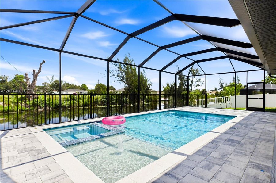 Step outside to SCREENED LANAI w/ HEATED POOL & SPA, landscape, SEAWALL & FULLY EQUIPED OUTDOOR KITCHEN Step outside to SCREENED LANAI w/ HEATED POOL & SPA, landscape, SEAWALL & FULLY EQUIPED OUTDOOR KITCHEN