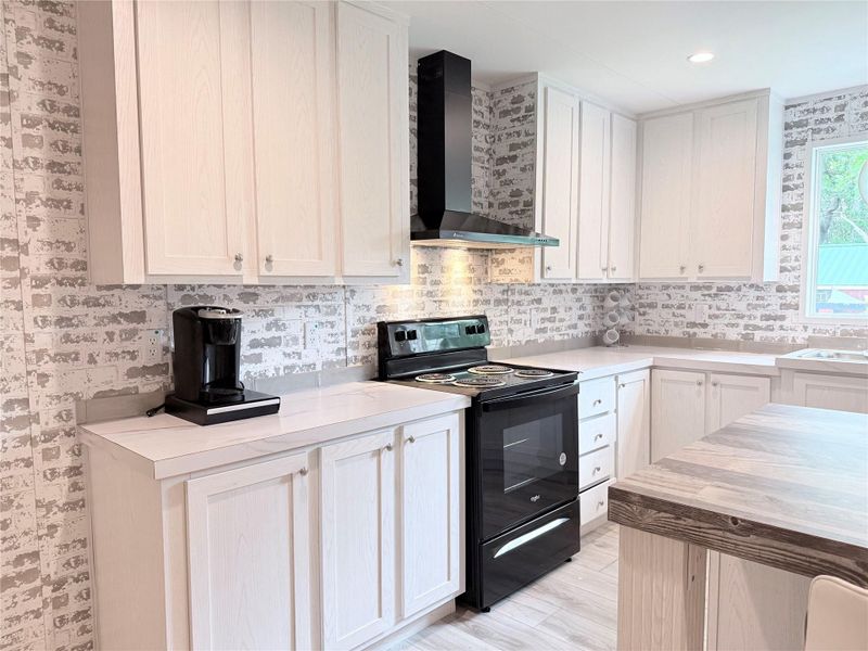 A well-equipped culinary space awaits in this modern kitchen, featuring pristine countertops and ample storage.