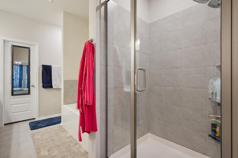 Master Bathroom featuring tile patterned flooring and separate shower and tub