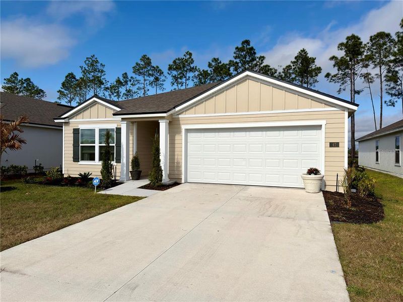 Front exterior of a new home in Sawmill Branch Express, Palm Coast, FL, highlighting curb appeal (Image 23).