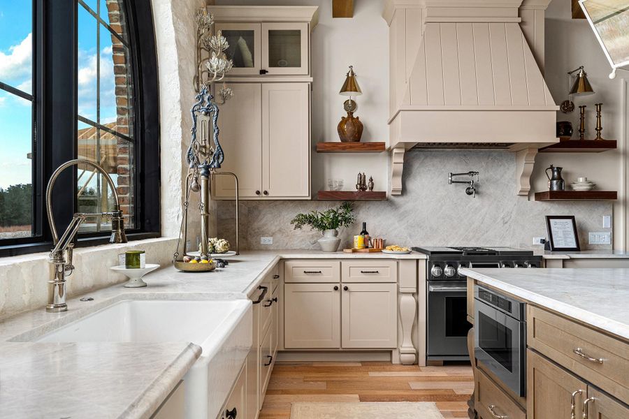 Kitchen featuring open shelves, appliances with stainless steel finishes, healthy amount of natural light, and custom exhaust hood