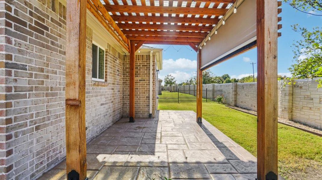 Fenced backyard featuring a pergola and a patio Fenced backyard featuring a pergola and a patio