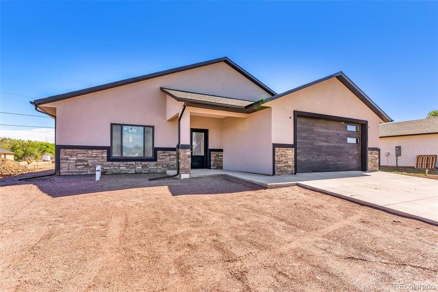 Front exterior of a new home in , Cañon City, CO, highlighting curb appeal (Image 23).