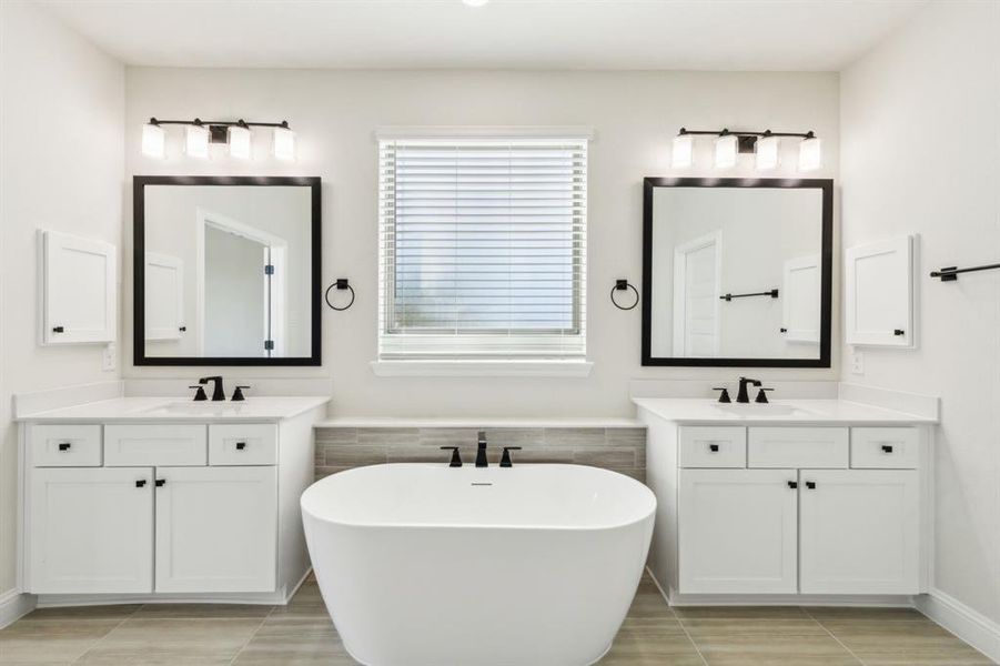 Bathroom with vanity, a tub to relax in, and tile patterned floors