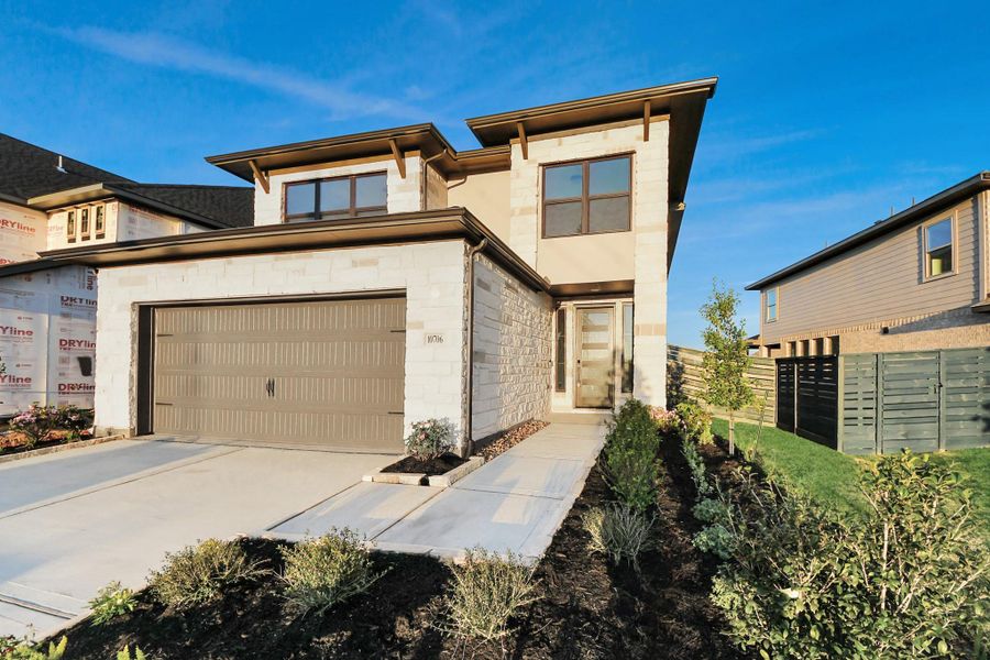 Front exterior of a new home in Austin Point, Richmond, TX, highlighting curb appeal (Image 22). Front exterior of a new home in Austin Point, Richmond, TX, highlighting curb appeal (Image 22).