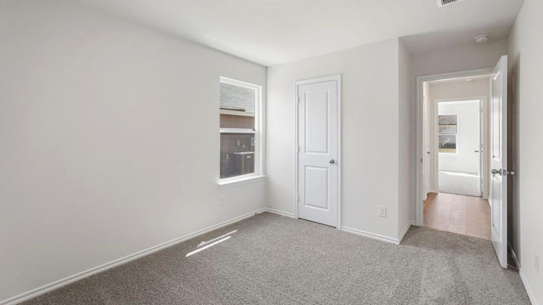 Carpeted room featuring a single window and neutral wall tones