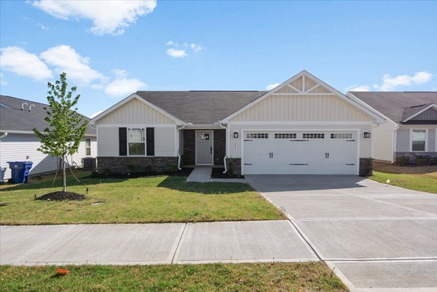 Front exterior of a new home in Reidville Town Center Cottages, Duncan, SC, highlighting curb appeal (Image 1). Front exterior of a new home in Reidville Town Center Cottages, Duncan, SC, highlighting curb appeal (Image 1).
