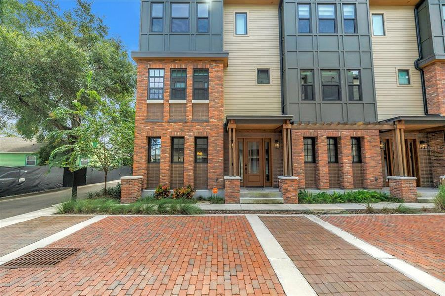 Front exterior of a new home in East Oak Townhomes, Tampa, FL, highlighting curb appeal (Image 25).
