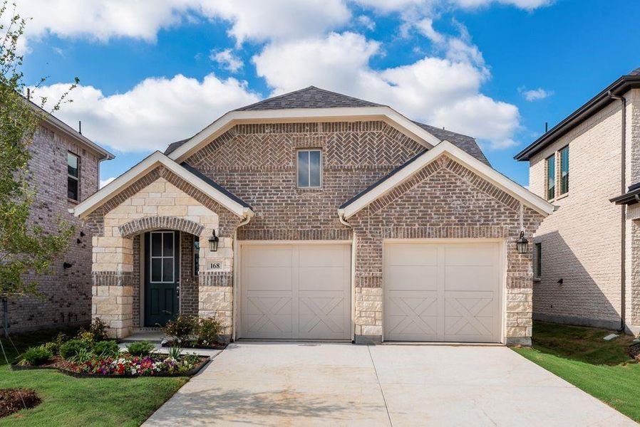 Front exterior of a new home in Spiritas Ranch, Little Elm, TX, highlighting curb appeal (Image 2). Front exterior of a new home in Spiritas Ranch, Little Elm, TX, highlighting curb appeal (Image 2).