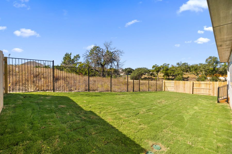 Exterior details and patio area of a home in Lariat, Liberty Hill (Image 30).