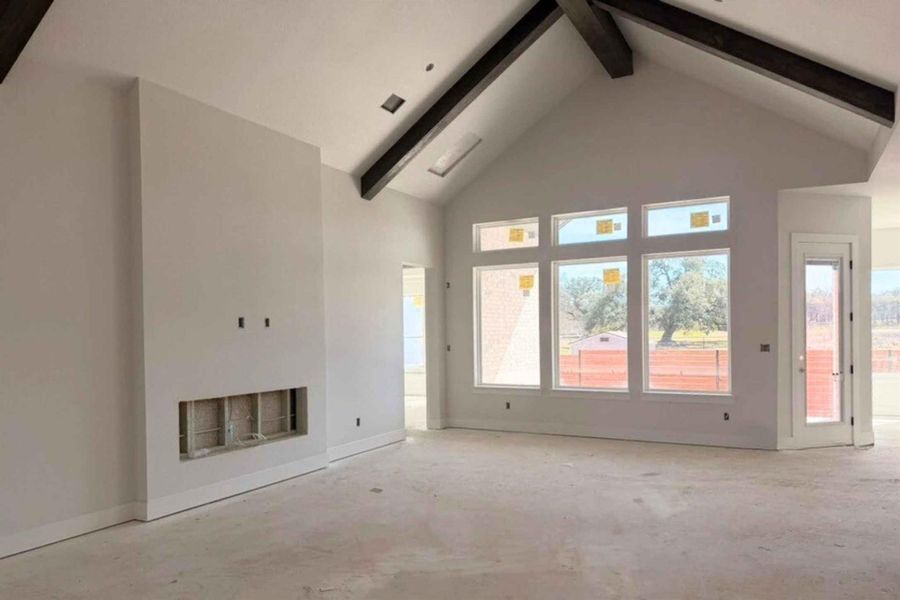 Unfurnished living room with a fireplace and plenty of natural light
