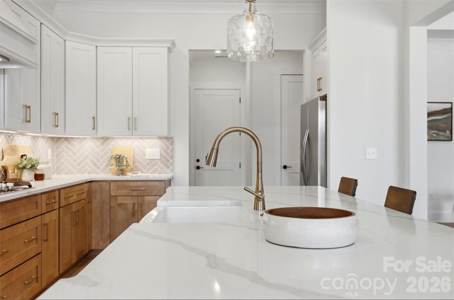 gourmet kitchen- custom  wood hood vent, porcelain farmmhouse sink, high quality quartz island, double oven, gas cooktop