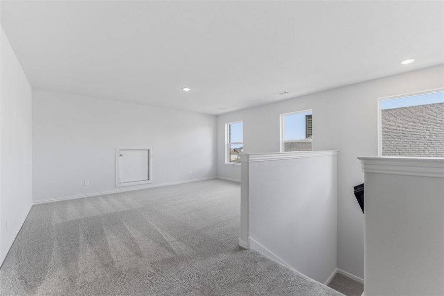 Carpeted empty room with recessed lighting