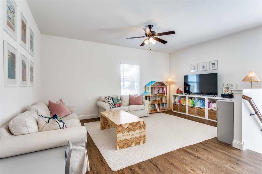 Living room featuring hardwood / wood-style floors and ceiling fan