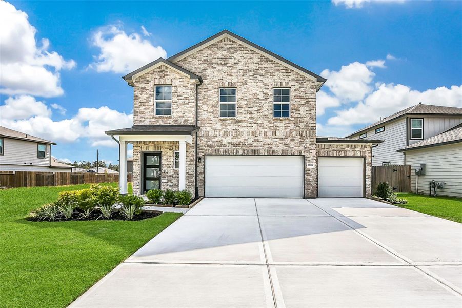 Front exterior of a new home in Hill and Dale Ranch, Splendora, TX, highlighting curb appeal (Image 2). Front exterior of a new home in Hill and Dale Ranch, Splendora, TX, highlighting curb appeal (Image 2).