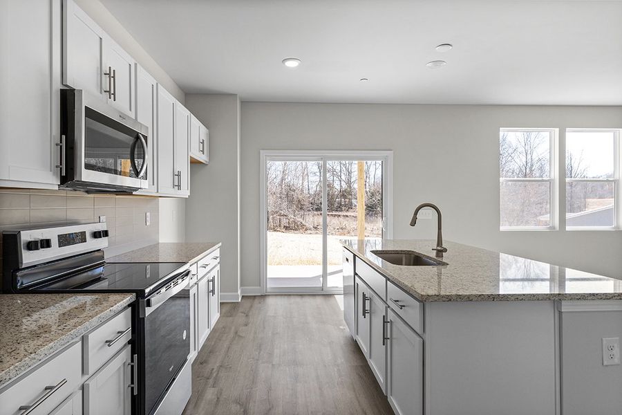 A kitchen with a large window. A kitchen with a large window.