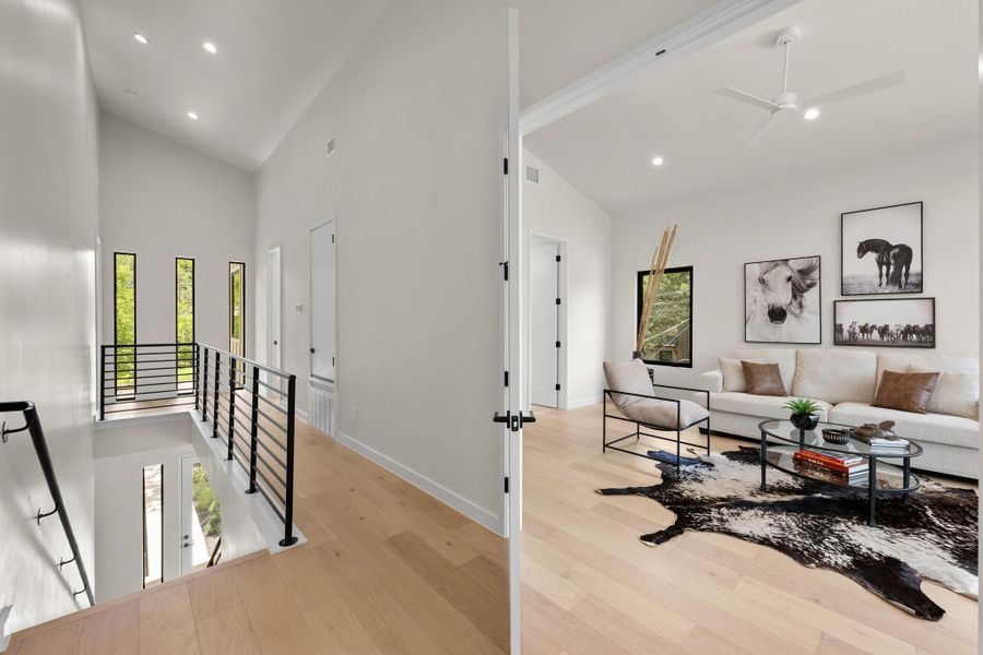 Hardwood flooring extends throughout this naturally illuminated hallway, connecting to a sophisticated living area. Hardwood flooring extends throughout this naturally illuminated hallway, connecting to a sophisticated living area.