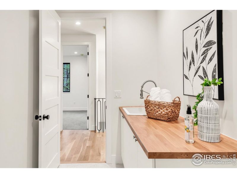 2nd floor laundry with sink and storage