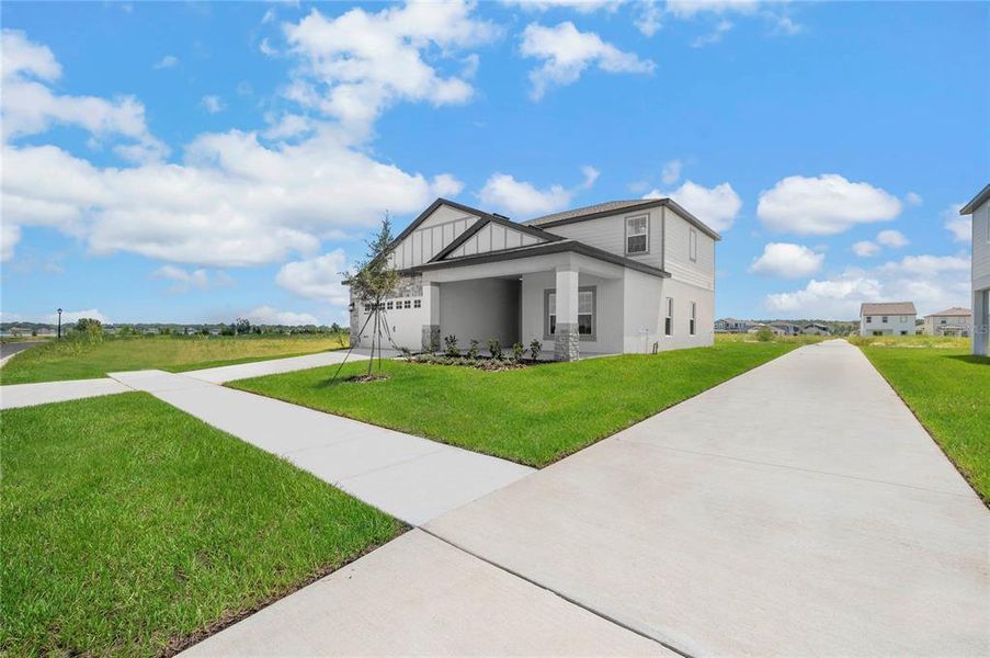 Front exterior of a new home in Gum Lake Preserve, Lake Alfred, FL, highlighting curb appeal (Image 18).