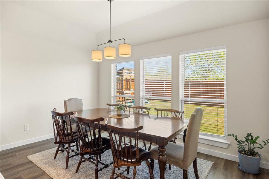 Dining space with dark wood finished floors and baseboards