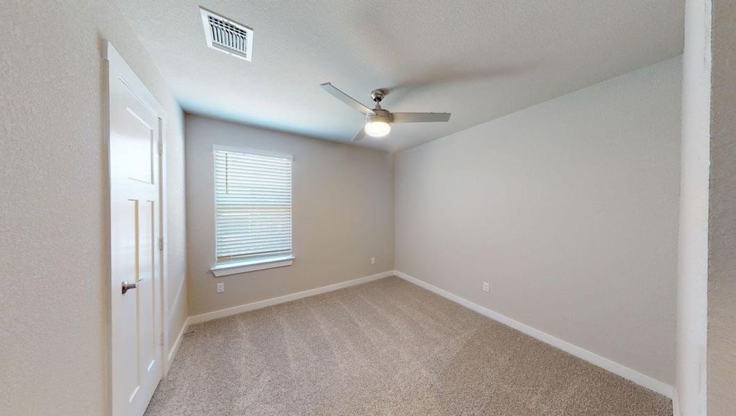 Unfurnished room featuring light carpet and a ceiling fan