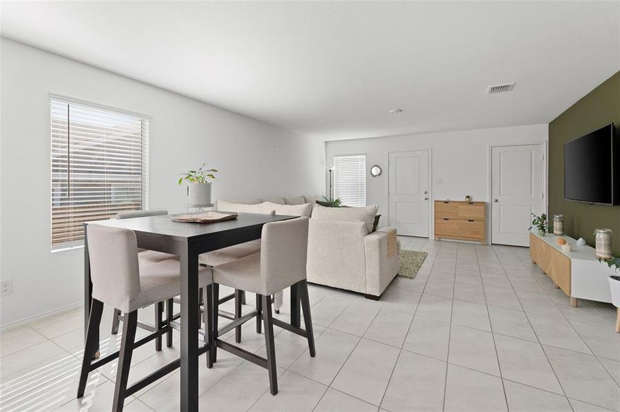 Dining space featuring light tile patterned flooring