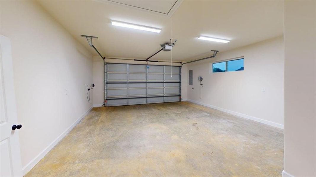 Garage with electric panel and a garage door opener