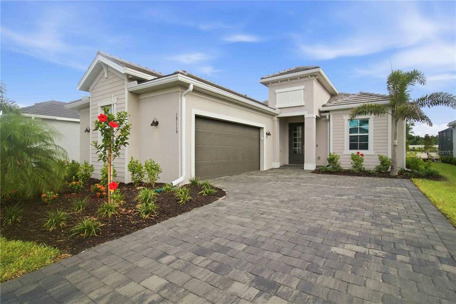 Front exterior of a new home in Calusa Country Club, Lakewood Ranch, FL, highlighting curb appeal (Image 2).