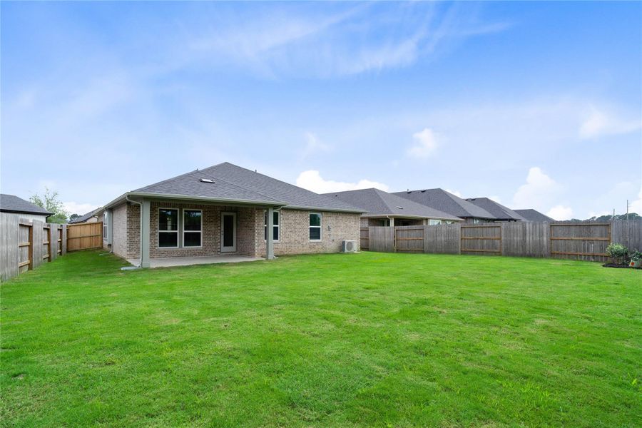 The backyard green space is fully fenced for added privacy.