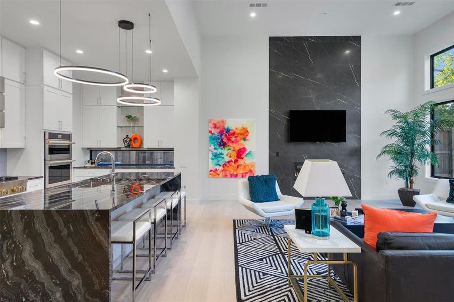 Living area with light wood-type flooring and recessed lighting Living area with light wood-type flooring and recessed lighting