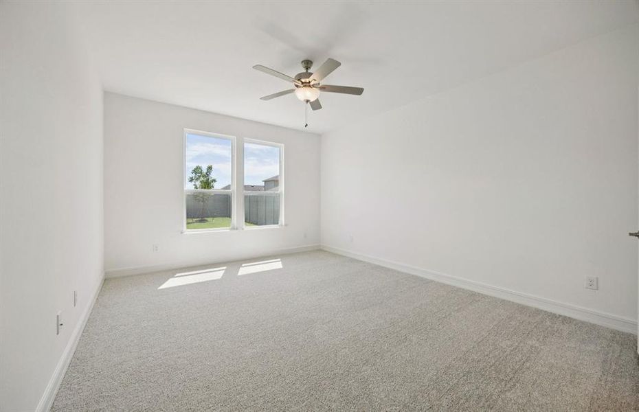 Elegant owner's suite with large windows  *real home pictured