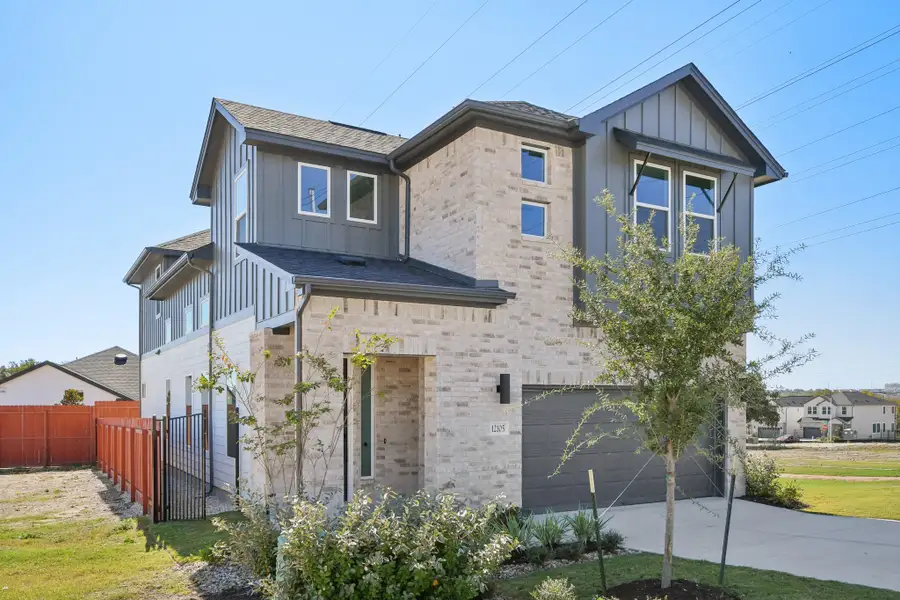 Front exterior of a new home in Foxfield, Austin, TX, highlighting curb appeal (Image 2). Front exterior of a new home in Foxfield, Austin, TX, highlighting curb appeal (Image 2).