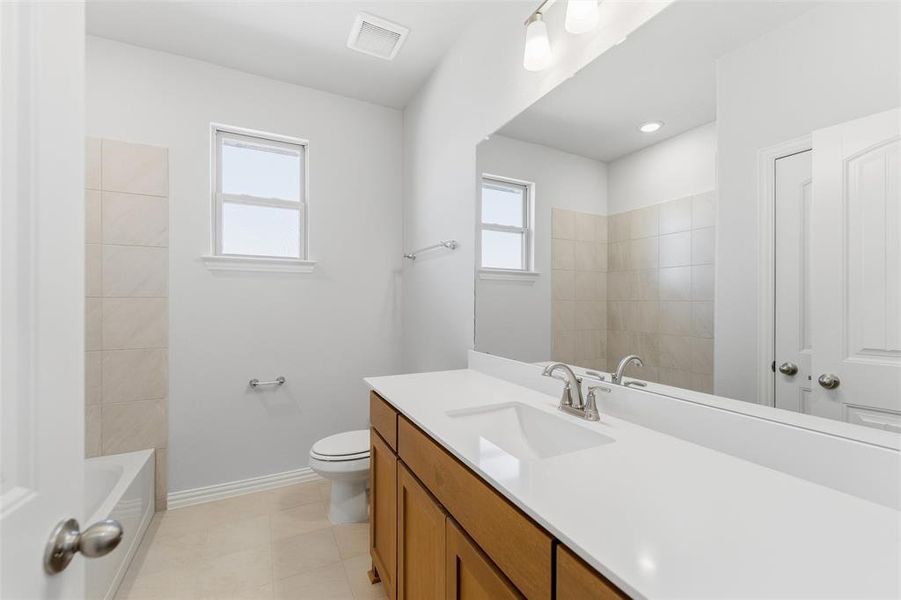 Bathroom with vanity and washtub / shower combination