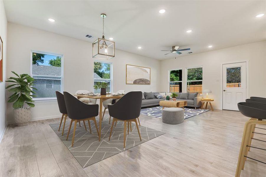 Dining room with recessed lighting, light wood finished floors, a ceiling fan, and a chandelier